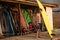 Handsome curly man surfer standing and holding yellow surfing board