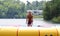 Handsome cute man jumping at a water trampoline floating in a lake in Michigan during summer.