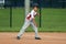 Handsome cute Young boy playing baseball waiting and protecting the base.