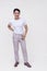 A handsome dapper FIlipino guy in a white shirt and light gray pants. Whole body photo, isolated on a white background