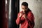 Handsome dark-skinned boxer in a sport wear is practicing the hooks and blows in front of the punching bags.