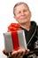 Handsome elderly man holding gift boxes