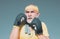 Handsome elderly man practicing boxing kicks - close up portrait. Healthy fighter senior old man boxing gloves