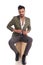 Handsome elegant man unbuttoning suit jacket while sitting