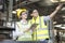 Handsome engineer in a factory. Professional technicians are holding a tablet to control work in industrial plants