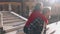 Handsome european man carrying on his back gorgeous asian woman in the streets of Venice. Young hipster couple in love