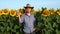 Handsome farmer man is gesturing to stop with hand and finger waving NO. Handsome farmer in a sunflower field.