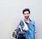 Handsome fashion man with beard holding travel bag