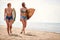 Handsome female surfers on a beach