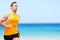 Handsome Fit Running Man Jogging On Shore At Beach