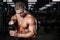 Handsome fitness model holding a shaker in the gym gain muscle