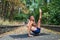 Handsome flexible Athletic man doing yoga asanas in the park