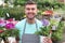 Handsome florist smiling at work