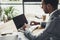 handsome focused businessman working with laptop