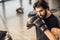 handsome focused young man in boxing gloves exercising