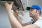 Handsome foreman fixing exhaust hood.