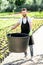 Handsome gardener with huge bucket