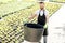 Handsome gardener with huge bucket