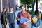 Handsome german male student with group of young adults outdoor in city