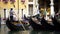 Handsome gondoliers entertaining tourists, giving ride around Venice sights