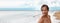 Handsome good looking man swimming at beach looking to the side on copy space banner. Male beauty model smiling portrait