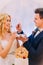 Handsome groom feeding his beautiful blonde bride with wedding cake