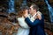 Handsome groom softly touches face of his bride. Waterfall on background