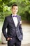 Handsome groom at wedding tuxedo smiling and waiting for bride