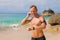 Handsome guy fixing his earbuds and getting ready for workout on the beach