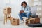 handsome guy sitting on a chair with boxes interior moving interior