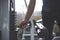 Handsome hand change weight on Iron heavy plates stacked of weight machine in gym