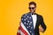 Handsome happy man in tuxedo and American flag