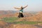 Handsome high jump man. A bald man wearing sunglasses in Hampi,