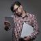 Handsome hipster busy man with many gadgets in hands.