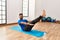 Handsome hispanic man doing exercise and stretching on yoga mat, practicing flexibility and training at the gym