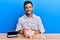 Handsome hispanic man with piggy bank saving for eyeglasses with a happy and cool smile on face