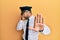 Handsome hispanic man wearing airplane pilot uniform covering eyes with hands and doing stop gesture with sad and fear expression