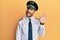 Handsome hispanic man wearing airplane pilot uniform waiving saying hello happy and smiling, friendly welcome gesture