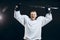 Handsome hockey player. Smiling at camera isolated on black background.