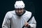 Handsome hockey player. Smiling at camera isolated on black background.