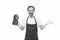 Handsome household worker. Mature man holding detergent bottle in rubber gloves. Senior man in apron ready for