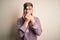 Handsome Irish redhead business man with beard wearing glasses over isolated background shocked covering mouth with hands for