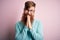 Handsome Irish redhead man with beard wearing glasses over pink isolated background praying with hands together asking for