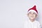 Handsome kid with Santa cap wishing or dreaming something. Child dreaming about Christmas gift. Kid looking up and thinking