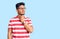 Handsome latin american young man wearing casual clothes and glasses touching painful neck, sore throat for flu, clod and