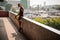 Handsome long-haired guy sitting on the parapet with longboard