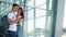 Handsome Lovely Couple standing near the Airport or Railway Station. They Pointing with her Finger in the Smartphone