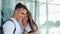 Handsome Lovely Couple standing near the Airport or Railway Station. They Pointing with her Finger in the Smartphone