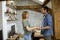 Handsome loving boyfriend smiling while holding hands of girlfriend in a loft apartment