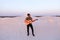 Handsome male Arab playing guitar standing in middle of bottomle